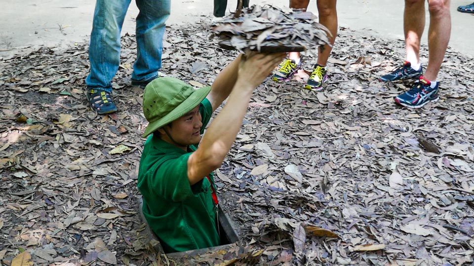 Demonstrating how the Cu Chi tunnels were concealed.